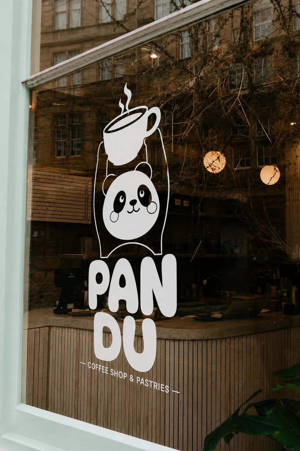 Pandu white vinyl window decal on the shop glass